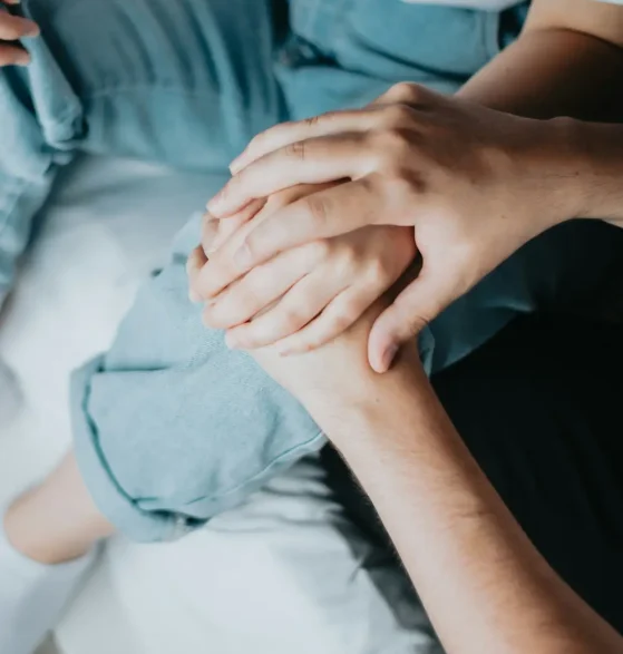Hands resting together during a supportive conversation